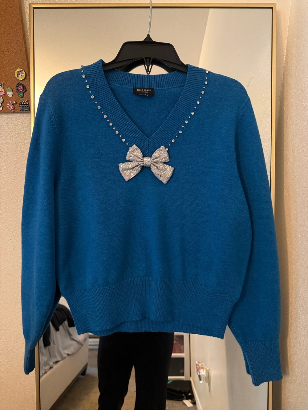 kate spade blue V-neck sweater with silver bow